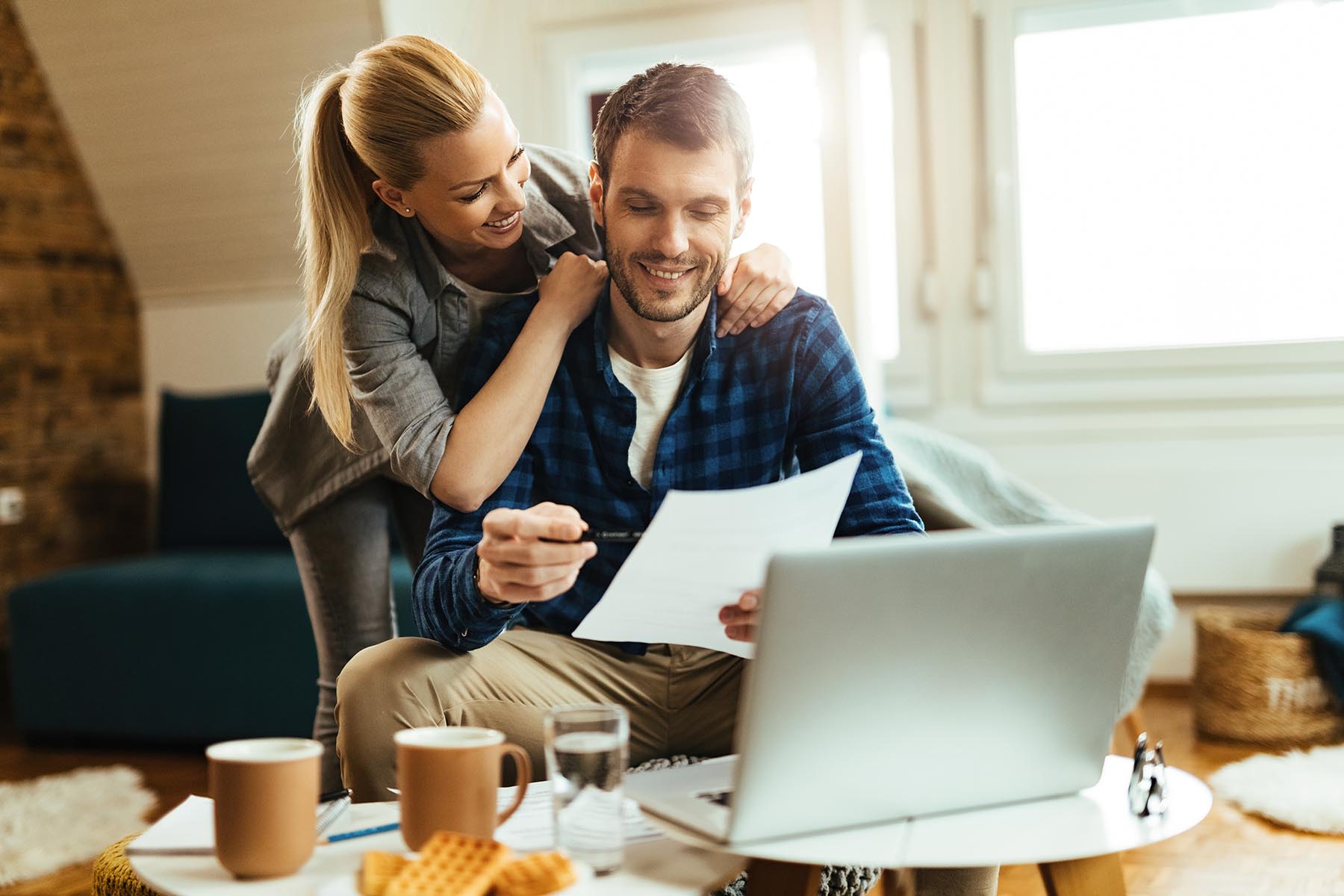 Young happy couple going through their finances at home. Contractor